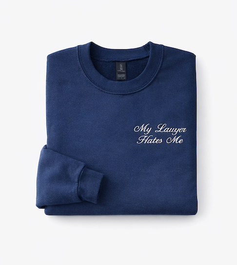 Folded navy blue sweatshirt with 'My Lawyer Hates Me' text on a white background